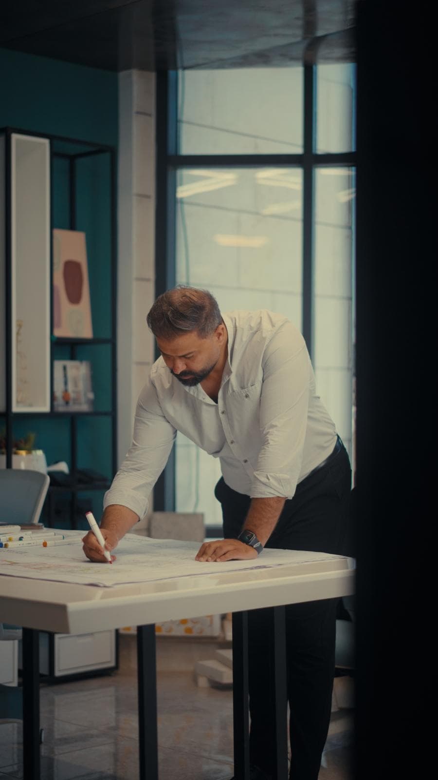 Oday Abu Doha, founder and design director of OD Architects, reviewing drawings at the studio